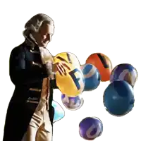 a man in a suit is holding a balloon with the letter f on it