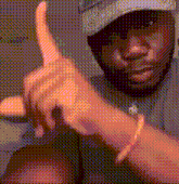 a man wearing a hat is giving a thumbs up