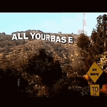a large sign on top of a hill that says all yourbase