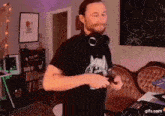 a man wearing headphones is dancing in a room with a couch .