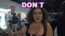a woman is standing in front of a sign that says ' do n't '