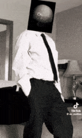 a man in a suit and tie has a picture of a planet on his head