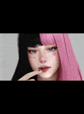 a girl with pink hair and black hair has the word love written on her face .