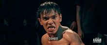 a man without a shirt is pointing at the camera and says diae