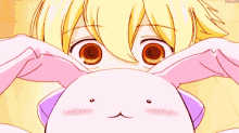 a close up of a girl holding a stuffed animal with bunny ears