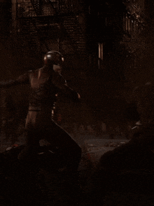 a man in a superhero costume is standing in a dark room