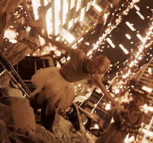 a woman in a white tutu is dancing in front of a building on fire
