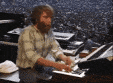 a man with a beard is playing an organ in front of a crowd