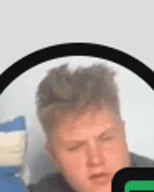a close up of a man 's face with his eyes closed and a circle around his head .