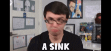 a man wearing glasses is making a funny face with the words a sink above him