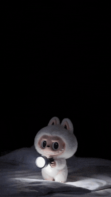 a stuffed animal is holding a flashlight in its hands