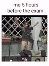 a man is dancing in front of a window with the words me 5 hours before the exam