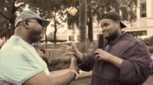 two men are giving each other high fives while talking into microphones .