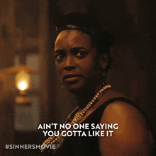 a woman in a black dress says " ain 't no one saying you gotta like it "