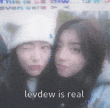 a blurred image of two girls with the caption levdew is real