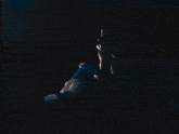 a blurred image of a person dancing in a dark room