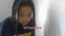 a young girl with dreadlocks is wearing a shirt that says weeee
