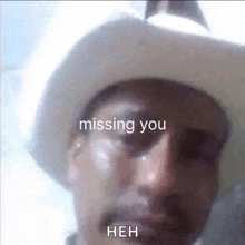 a man in a cowboy hat is crying with the words missing you behind him