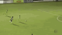 a soccer field with a banner that says sicoob in the background