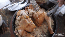 a person is cutting a piece of chicken with a fork on a plate that says made in animatica