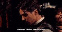 a man with a mustache and a woman behind him says " you know frederic fucking chopin "