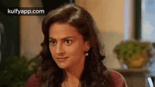 a woman in a red sweater is making a funny face .