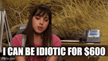a woman in a pink shirt is sitting at a desk with a phone and says `` i can be idiotic for $ 600 ''