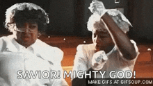 two women are sitting in a church talking on a cell phone and one of them is wearing a white hat .