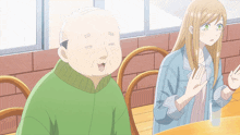 a man and a woman are sitting at a table in a restaurant