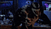 a man stands in a dark room with a computer monitor that says cobra