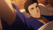 a man in a blue shirt is laying in a bed