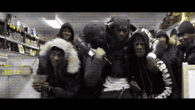 a group of men are posing for a picture and one of their hoodies says cream