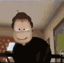 a cartoon character is wearing headphones and smiling while sitting in front of a computer .