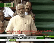 a man stands in front of a screen that says in the chair on it