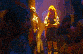 a skeleton is standing in the middle of a crowd of people in a dark room .