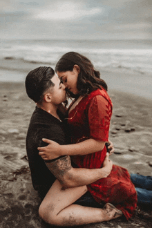 a man and a woman kissing on the beach