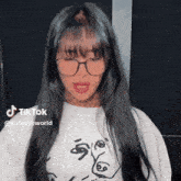 a woman wearing glasses and a t-shirt with a face on it