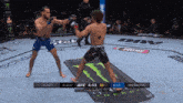 two fighters are fighting in a ufc ring with a monster energy drink in the background
