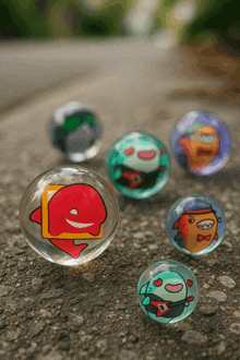 a group of marbles with cartoon characters on them are on the ground