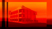 a red building with a sunset in the background .