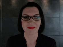 a woman with glasses and red lipstick says " you 're dangerous "