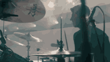 a man playing drums with a zildjian cymbal in the foreground