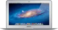 a macbook air laptop with a picture of the galaxy on the screen