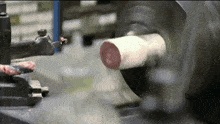 a piece of metal is being worked on by a machine that says ' tsc ' on it