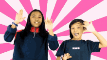 a girl wearing a blue shirt that says dream big stands next to a boy wearing a black shirt
