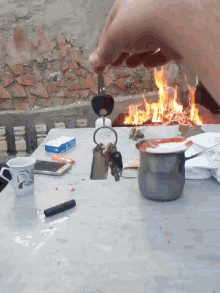a person is lighting a fire with a lighter