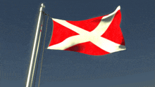 a red and white flag with a white cross is waving in the wind
