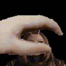 a pixel art of a hand holding a person 's head