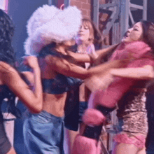 a group of women are having a fight in a club .