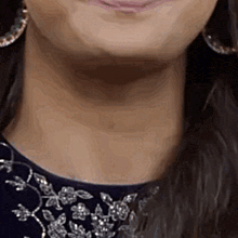 a close up of a woman 's neck and earring